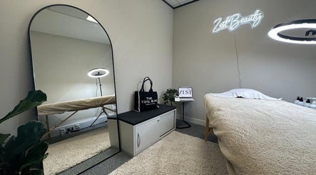 Elegant and serene treatment room at MSKN, Manchester, England, GB. Features a plush massage table and modern decor.
