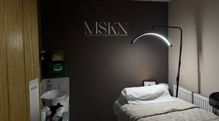 MSKN facial room with cozy bed and lamp in Manchester, England, GB, ideal for wellness treatments.