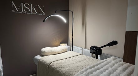 Luxurious treatment room at MSKN, Manchester, England, GB with plush bed and modern lighting.