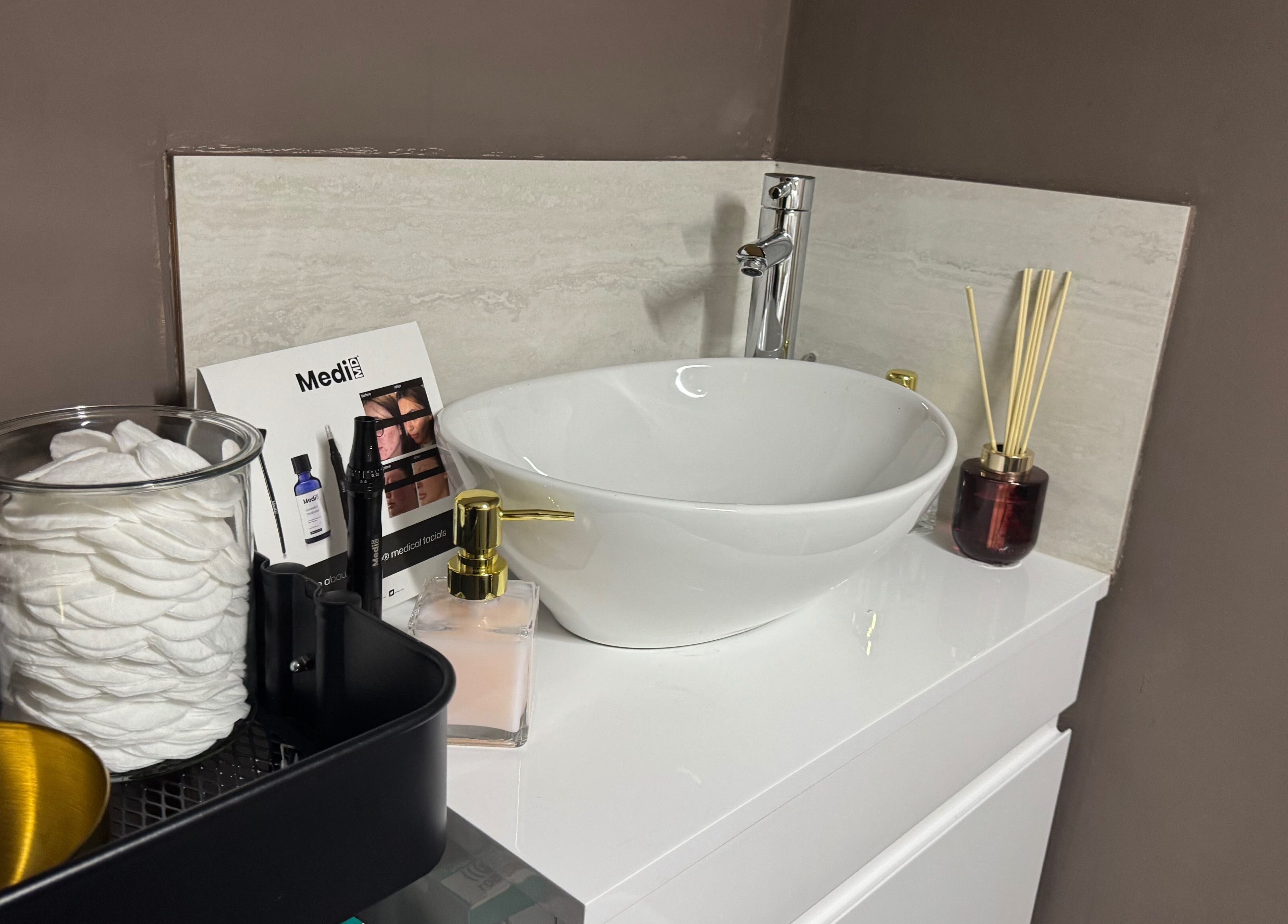 Elegant beauty station at MSKN, Manchester, England, GB featuring a stylish sink and skincare products.