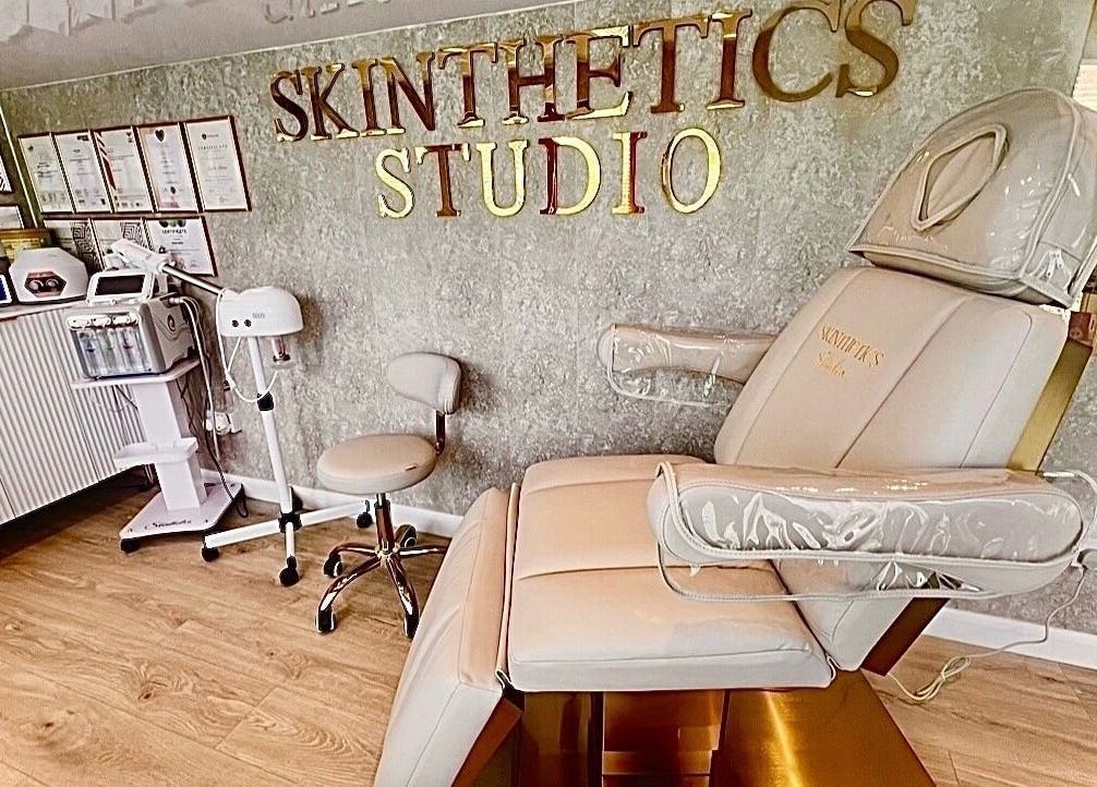 Elegant interior of Skinthetics Studio in Droitwich Spa, England, featuring a plush treatment chair and equipment.