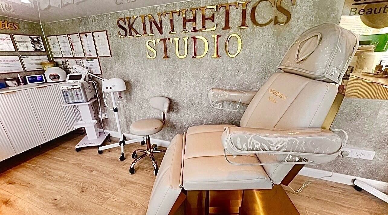 Elegant interior of Skinthetics Studio in Droitwich Spa, England, featuring a plush treatment chair and equipment.