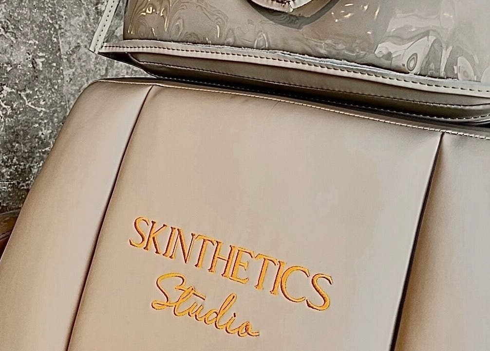 Elegant chair with Skinthetics Studio logo at Droitwich Spa, England, GB reflecting luxury.
