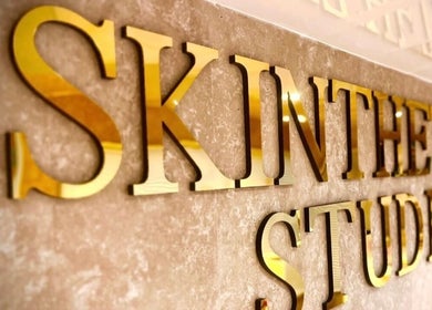 Golden Skinthetics Studio sign at Droitwich Spa, England, GB, reflecting elegance and luxury ambiance.