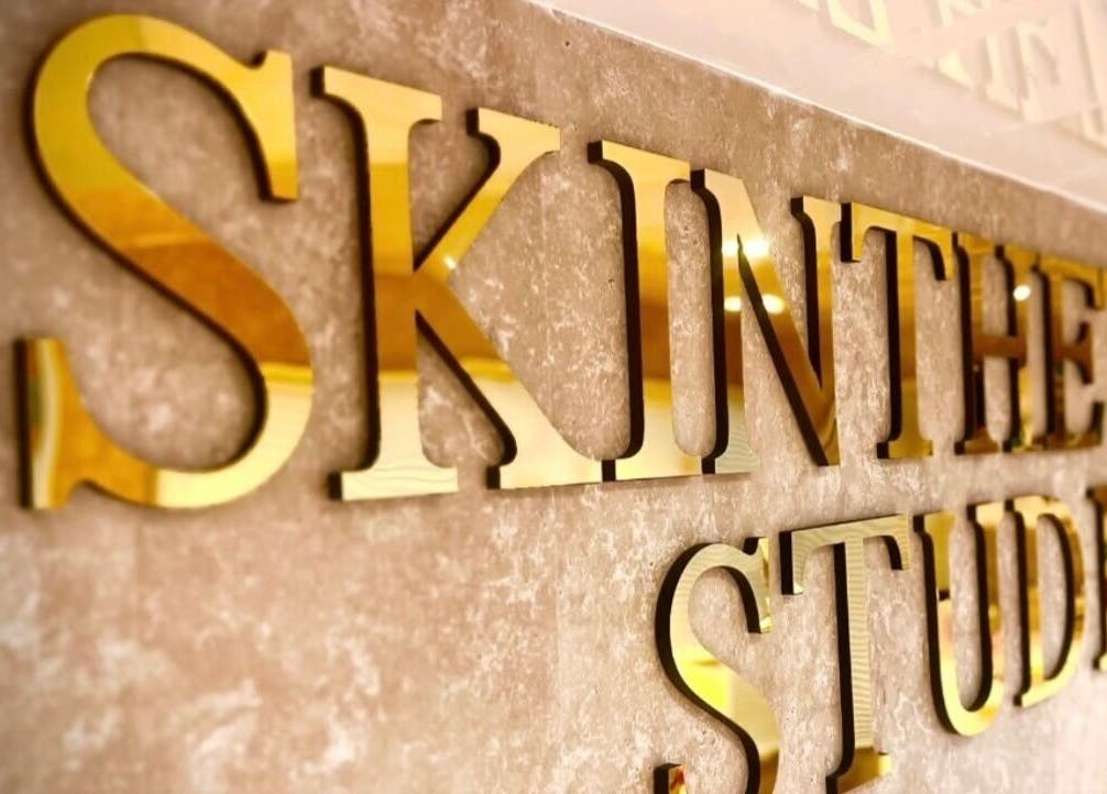 Golden Skinthetics Studio sign at Droitwich Spa, England, GB, reflecting elegance and luxury ambiance.