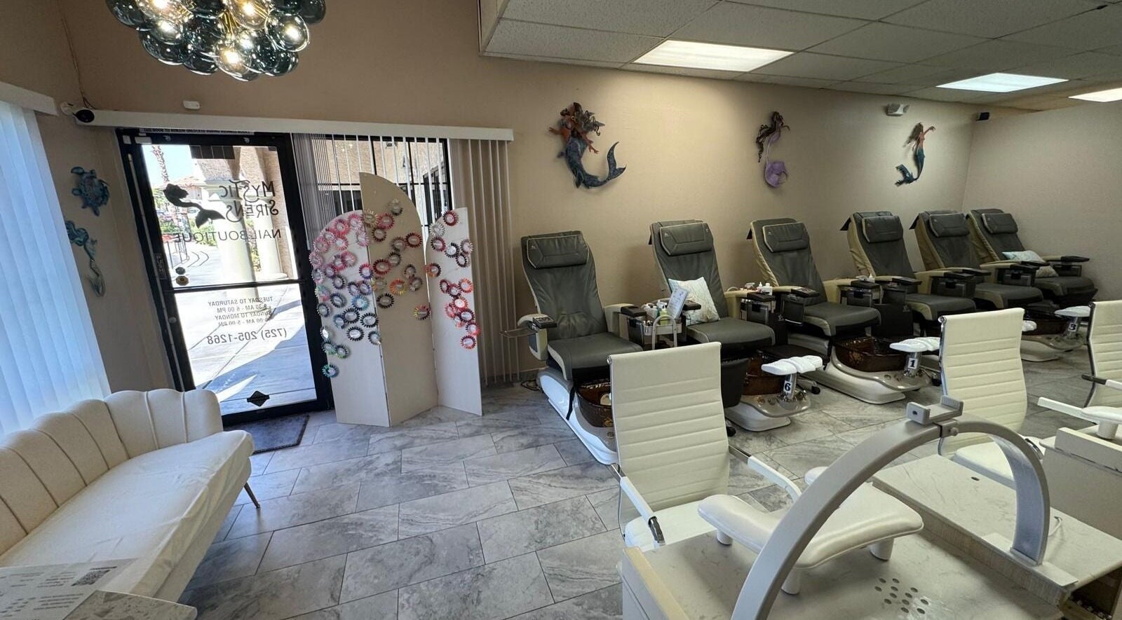 Chic interior of Mystic Sirens Nail Boutique in Las Vegas, Nevada with plush seating and decor.