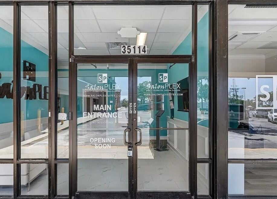 Stylish entrance of Glow Romantique, Palm Harbor, Florida, US, highlighting modern salon design.