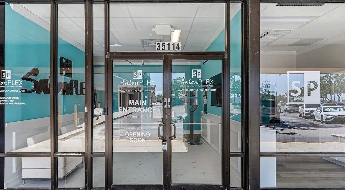 Stylish entrance of Glow Romantique, Palm Harbor, Florida, US, highlighting modern salon design.