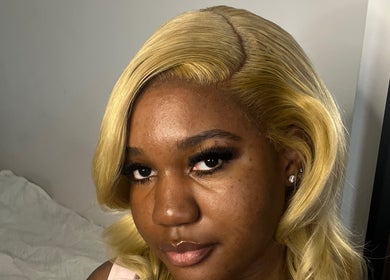 Close-up of a smiling woman with styled blonde hair at kmstylesuk, Leicester, England, GB.