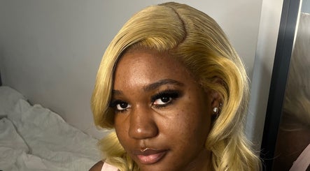 Close-up of a smiling woman with styled blonde hair at kmstylesuk, Leicester, England, GB.