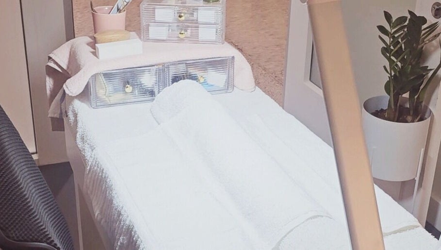 A serene spa room at Dazzlehood at Meta in Dublin, County Dublin, IE featuring a massage table and cozy ambiance.