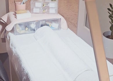 A serene spa room at Dazzlehood at Meta in Dublin, County Dublin, IE featuring a massage table and cozy ambiance.