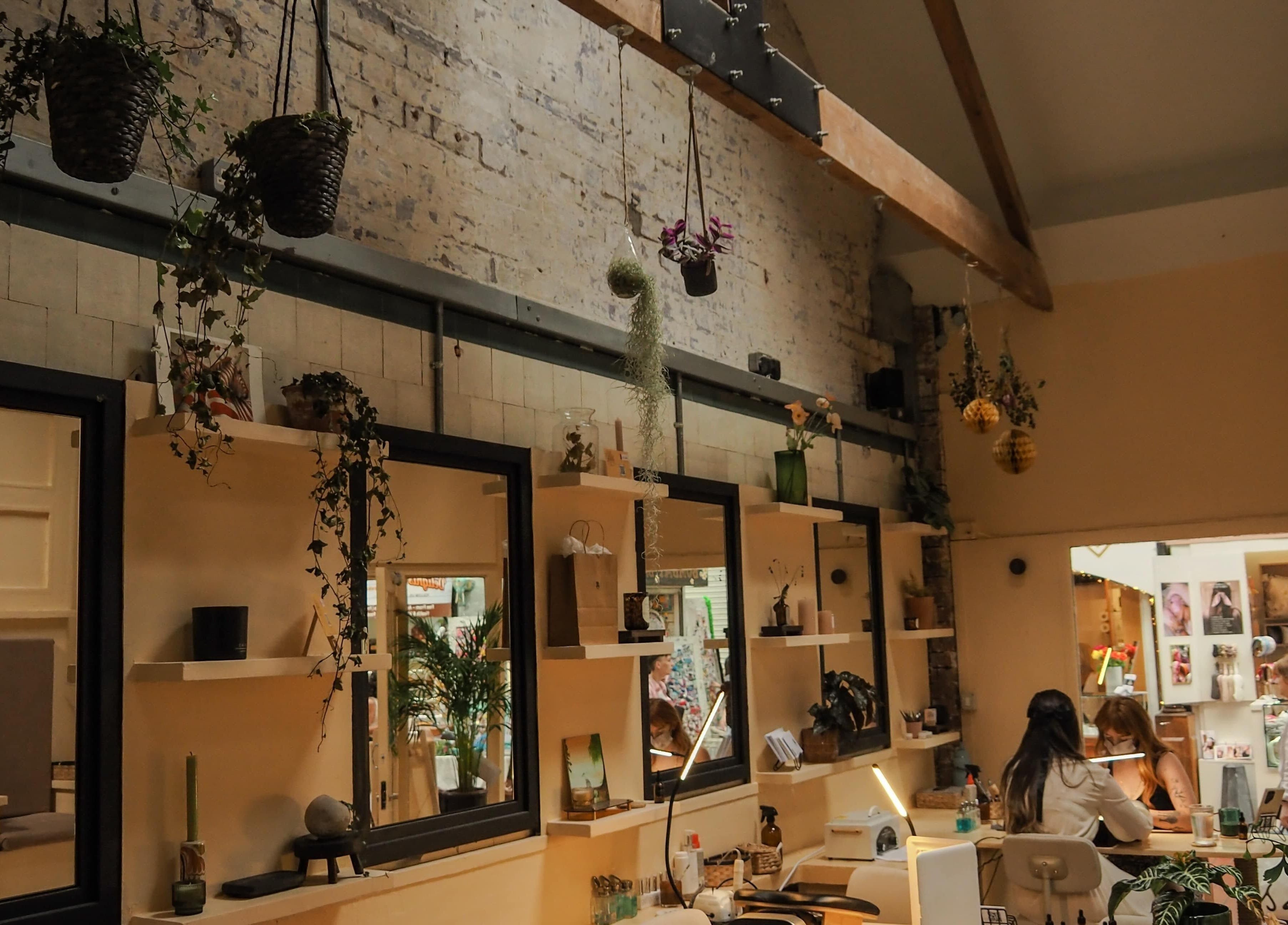 Interior of Hood Beauty Studio in Dublin, County Dublin, IE featuring rustic decor and elegant lighting.