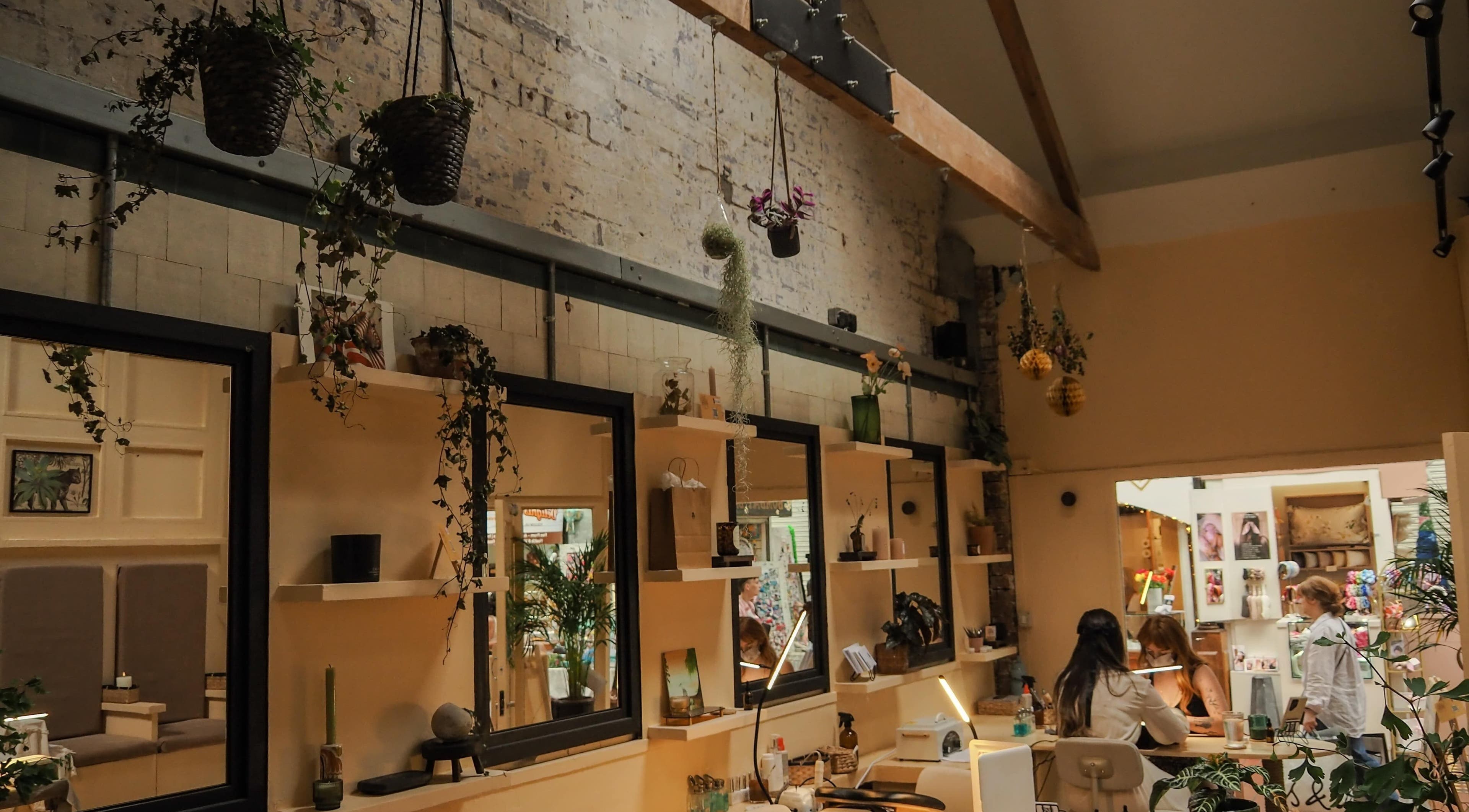 Interior of Hood Beauty Studio in Dublin, County Dublin, IE featuring rustic decor and elegant lighting.
