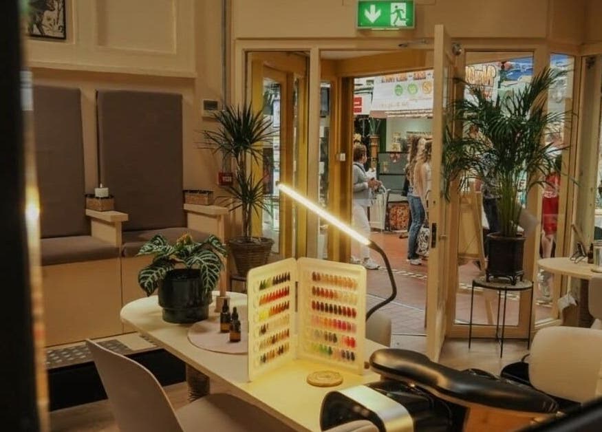 Relaxing interior of Hood Beauty Studio, Dublin, showcasing a nail station and lush plants.