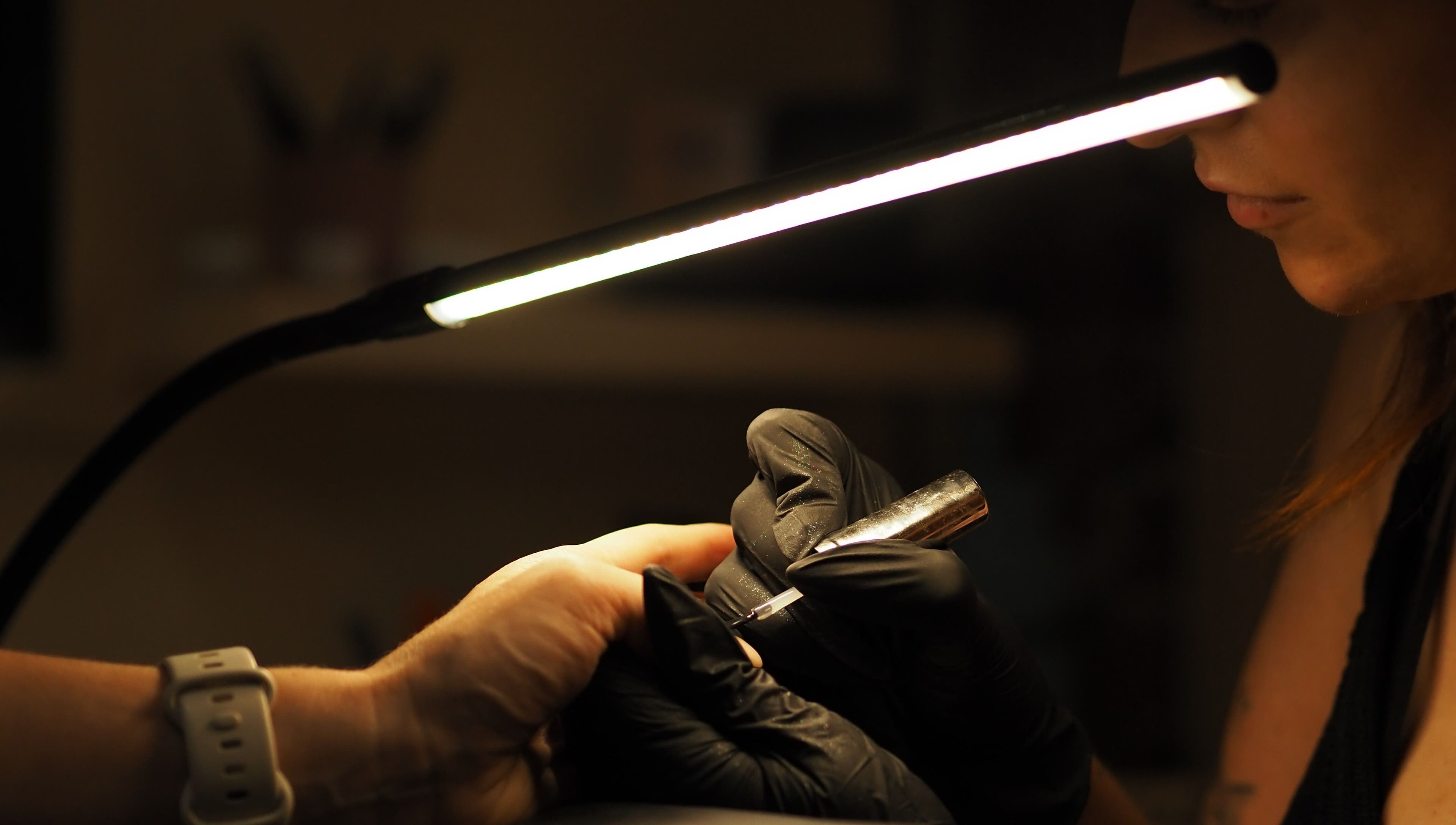 Nail technician crafting at Dazzlehood at Meta, Dublin, County Dublin, IE under soft light.