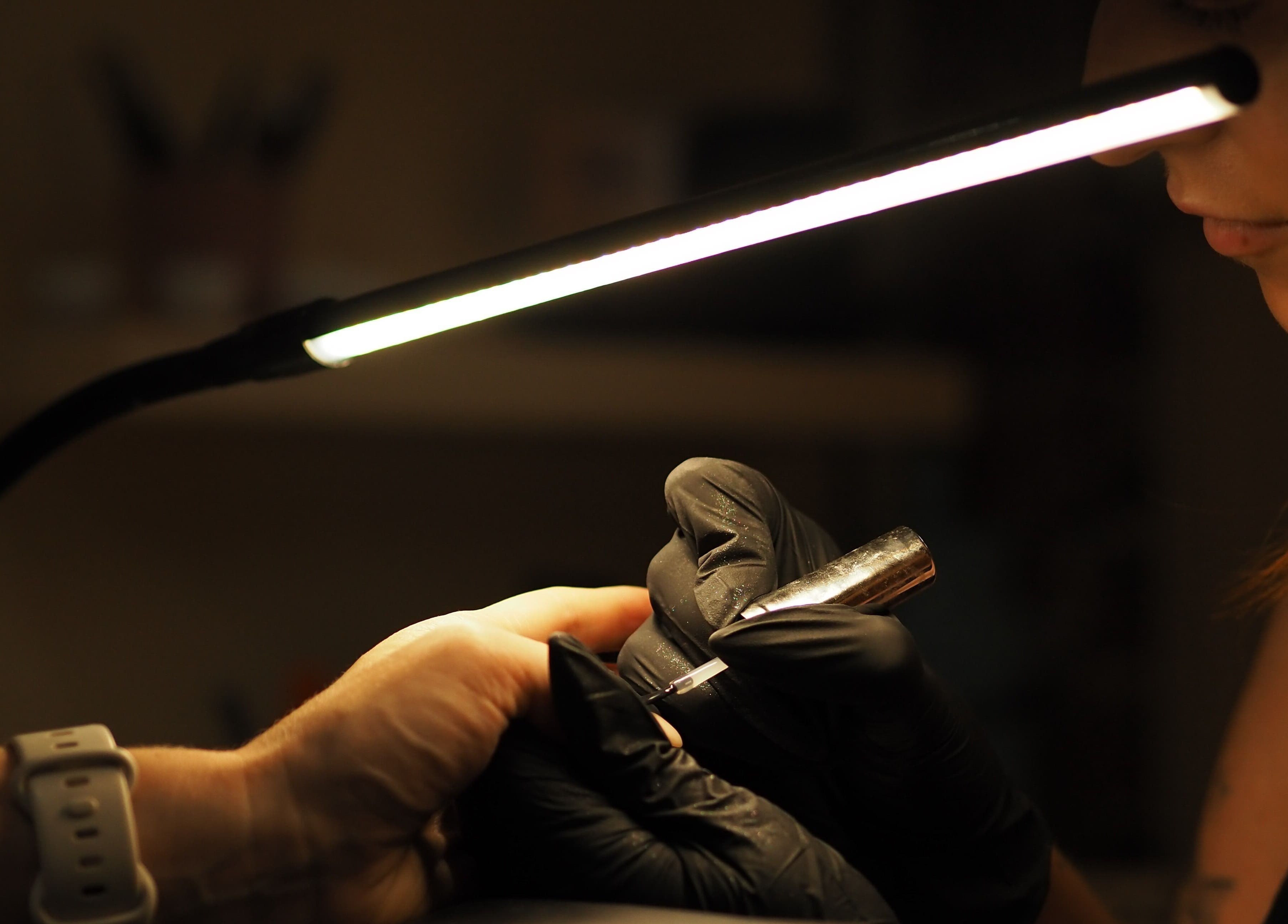 Nail technician crafting at Dazzlehood at Meta, Dublin, County Dublin, IE under soft light.