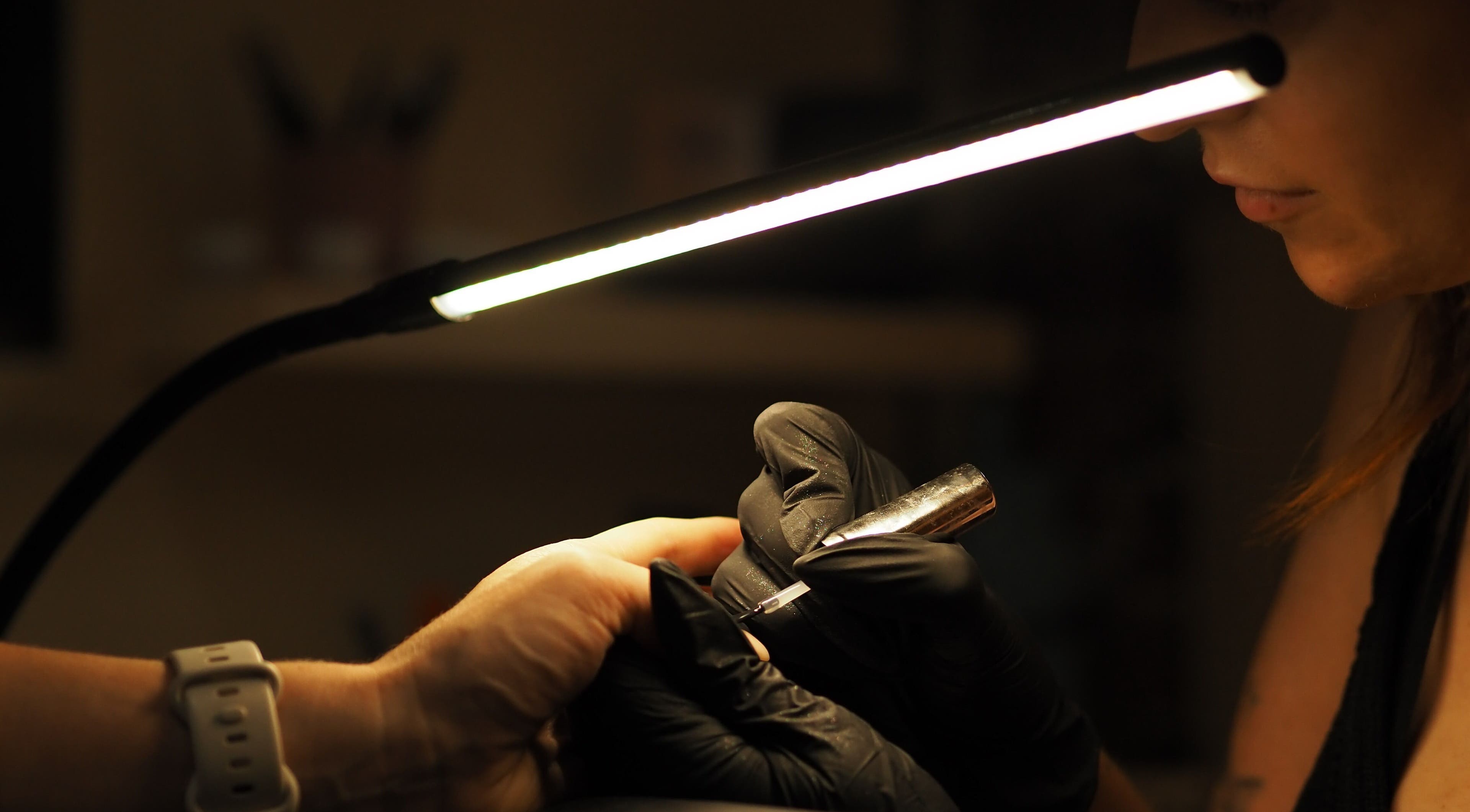 Nail technician crafting at Dazzlehood at Meta, Dublin, County Dublin, IE under soft light.