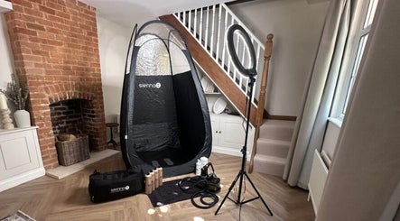 Glam + Tan's inviting tanning setup in Bishop's Stortford, England, GB with equipment and cozy ambiance.
