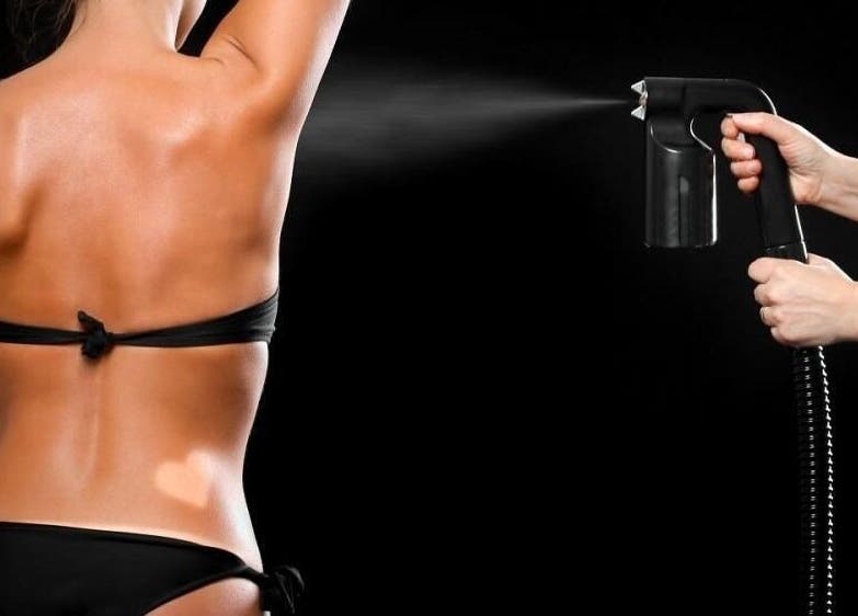 Spray tanning session at Glam + Tan, Bishop's Stortford, England, GB, showcasing a flawless bronzed look.