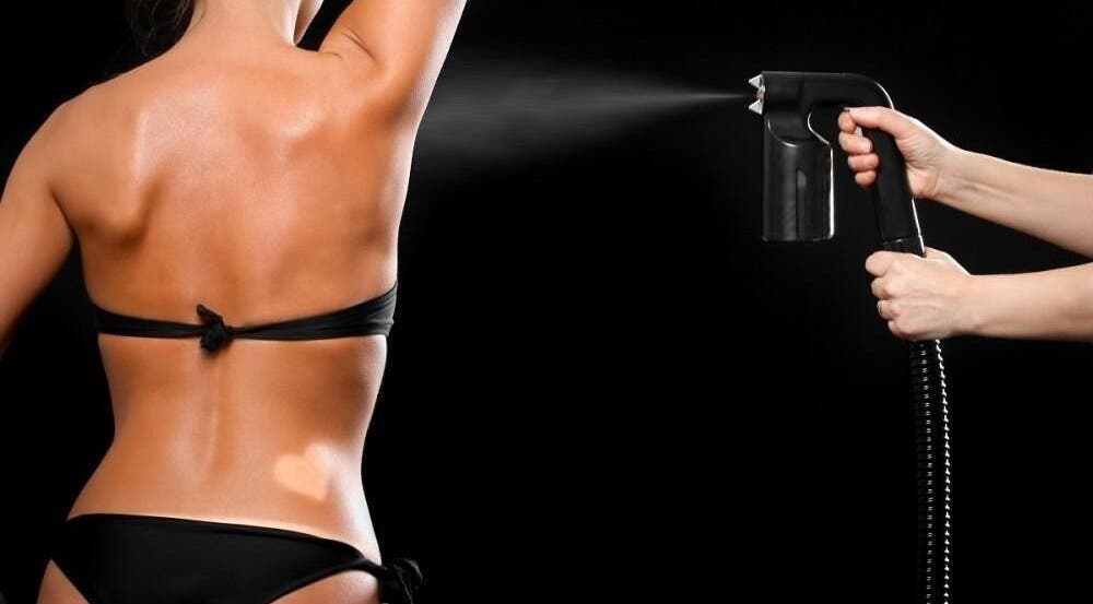 Spray tanning session at Glam + Tan, Bishop's Stortford, England, GB, showcasing a flawless bronzed look.