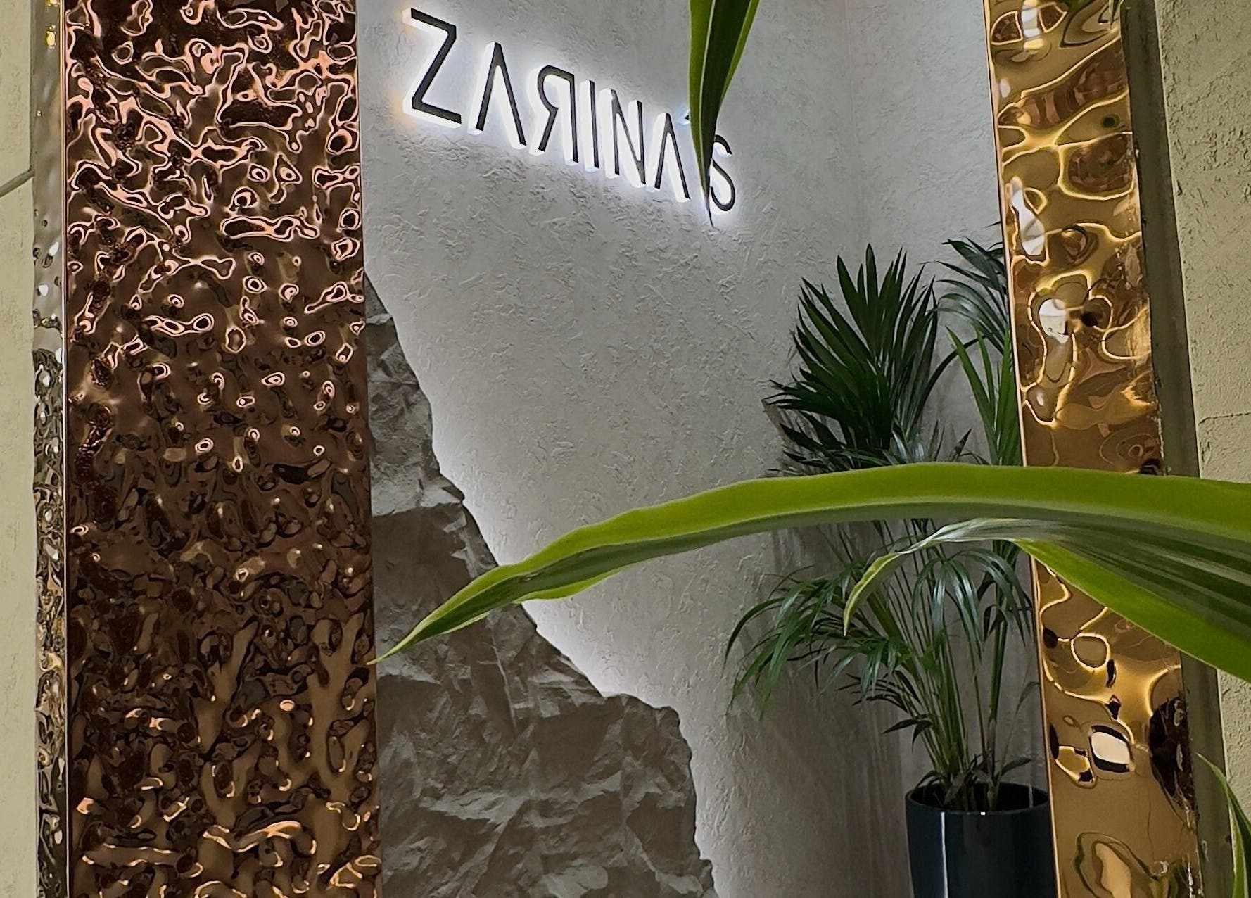 Sleek interior design at Zarina's Jabriya, Jabriya, Hawalli Governorate, KW. Featuring modern accents and lush plants.
