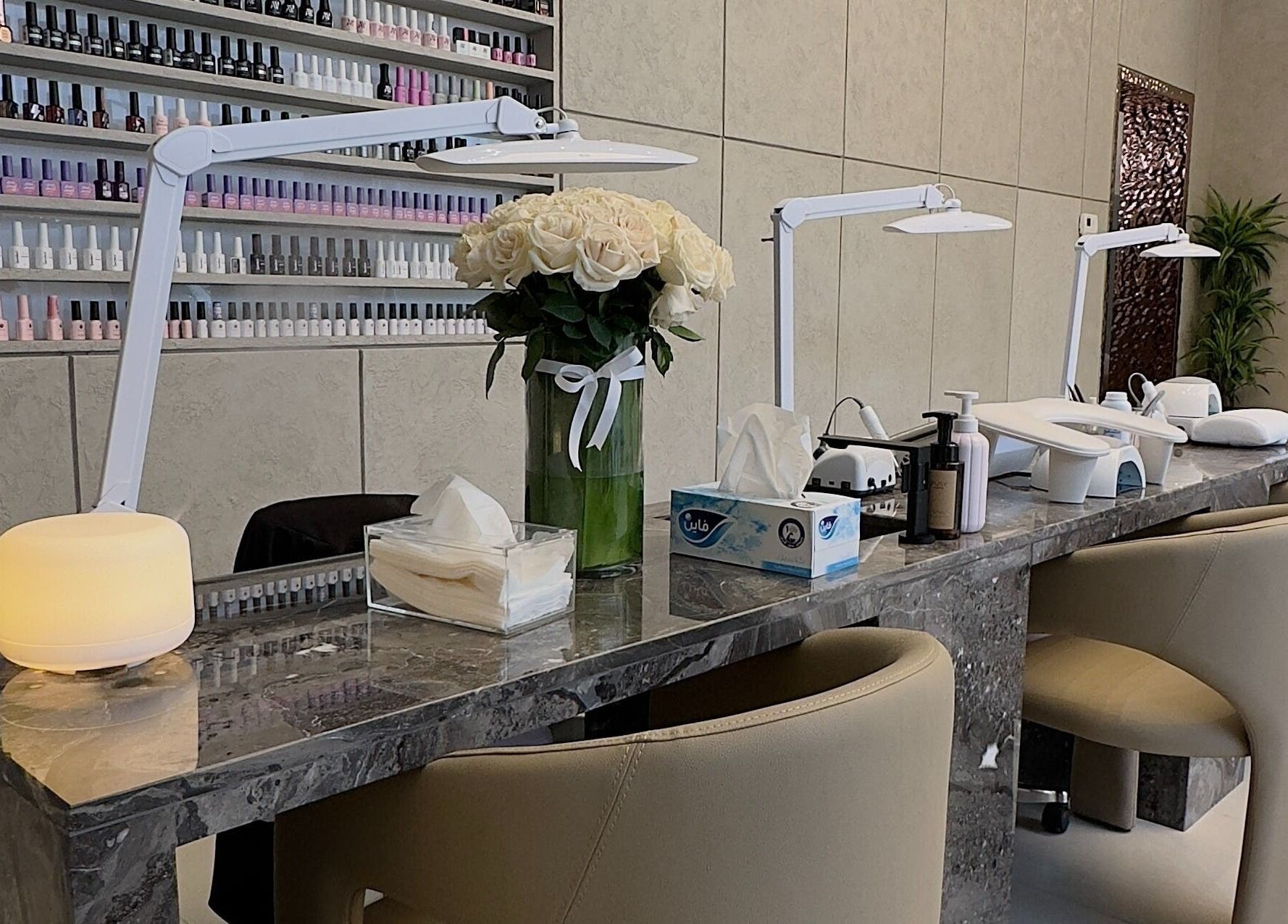 Chic nail station at Zarina's Jabriya, Jabriya, Hawalli Governorate, KW, featuring plush seating and nail polish display.