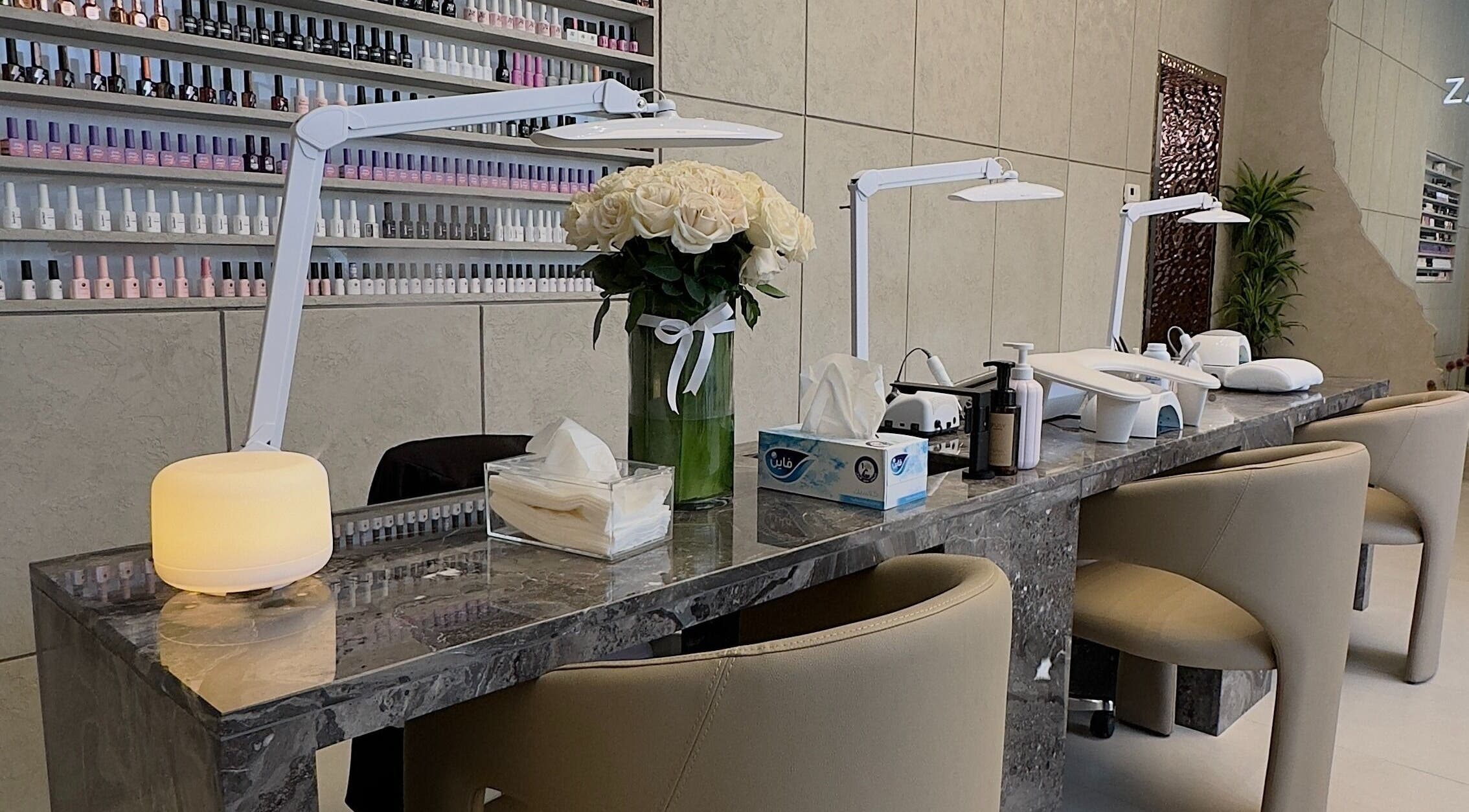 Chic nail station at Zarina's Jabriya, Jabriya, Hawalli Governorate, KW, featuring plush seating and nail polish display.