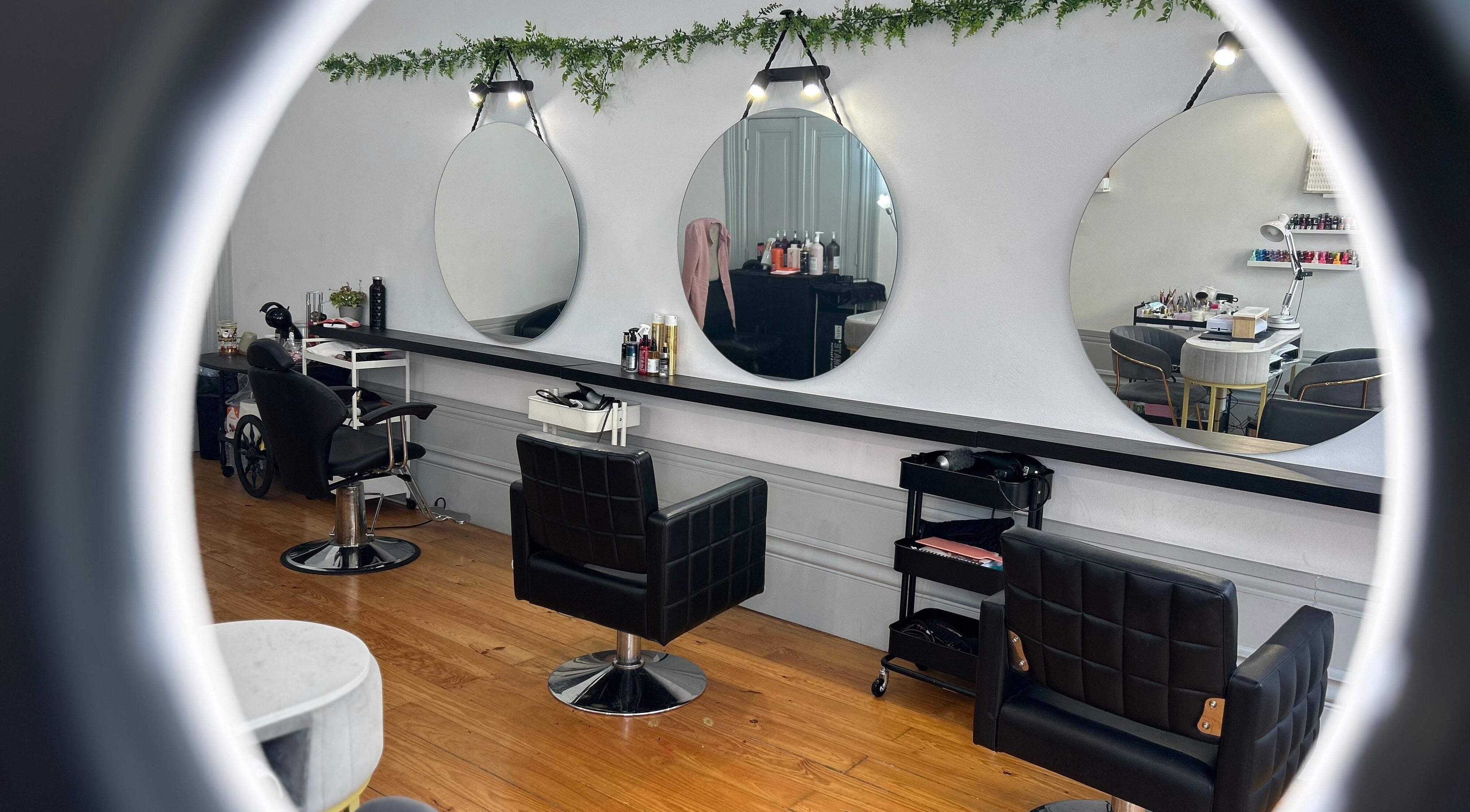 Interior sofisticado do Pamela Schaffer Brazilian Salon em Porto, Porto, PT, com cadeiras de salão modernas e espelhos.