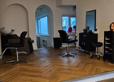Modern salon interior at Hair by Kieren in Scarborough, England, GB featuring sleek styling chairs and decor.