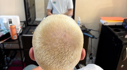 Blonde buzz cut hairstyle at Hair by Kieren in Scarborough, England, GB. Modern salon interior visible.