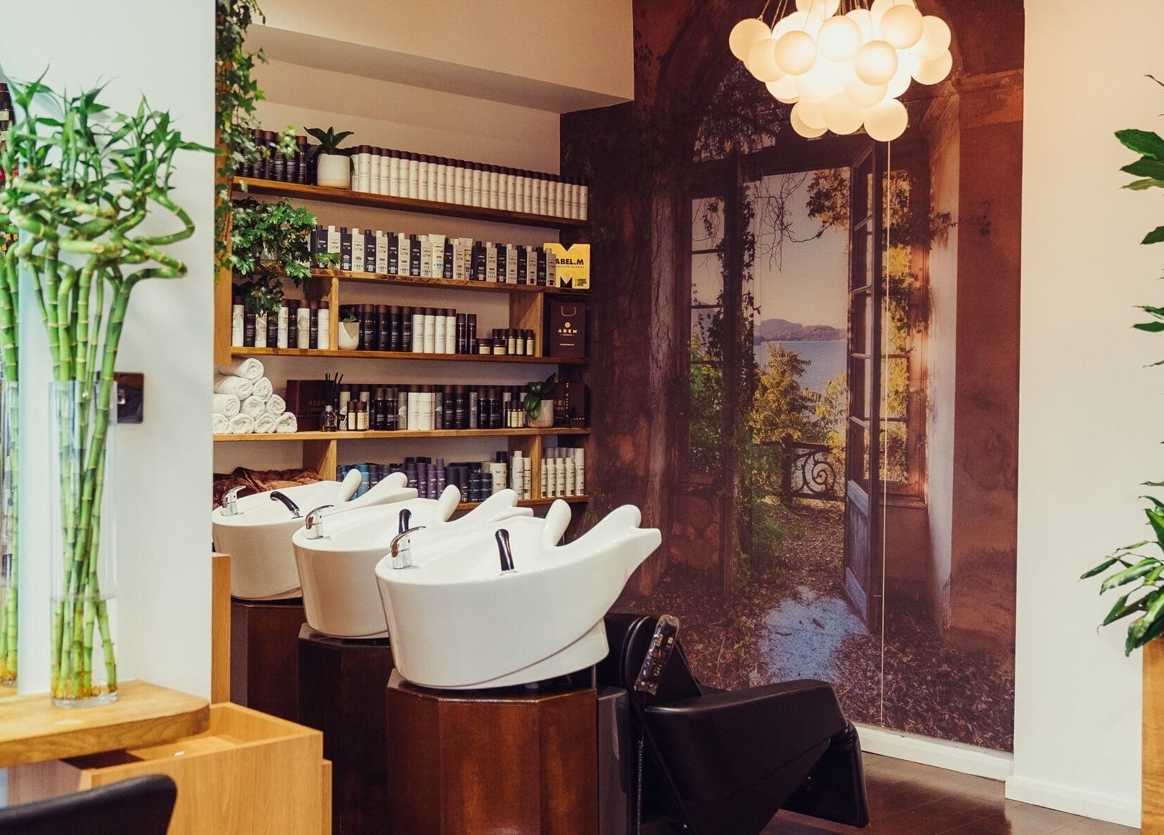 Relaxing salon interior at ADEM, London, England, GB with bamboo decor and modern wash stations.