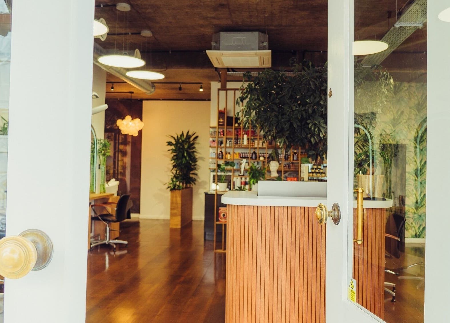 Entrance of ADEM in London, England, GB features inviting interiors with plants and stylish decor.