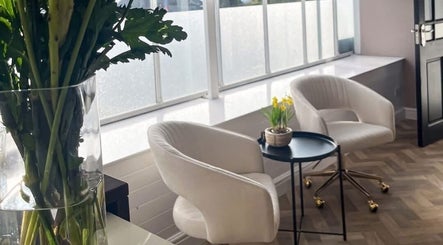 Stylish seating area with white chairs at In motion clinic, Upton, Cheshire, England, GB.