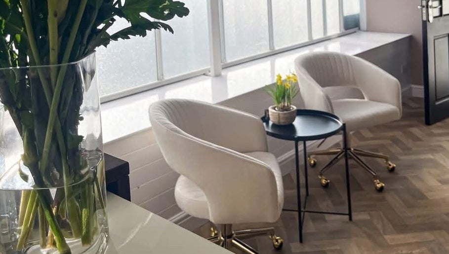 Elegant seating area at The Beauty Lounge in Tarporley, England, GB with bright natural light and decor.