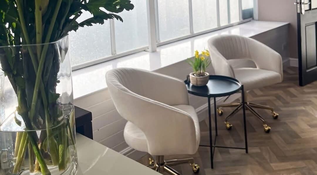 Elegant seating area at The Beauty Lounge in Tarporley, England, GB with bright natural light and decor.