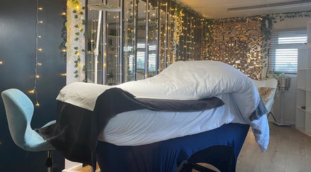 Tranquil massage room at Massage by Owen, Marden, England, GB, featuring soft lighting and cozy furnishings.
