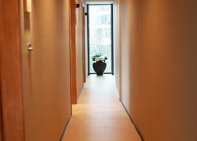 Calm hallway at Chanle Wellness Service in London, England, GB with a decorative plant at the end.