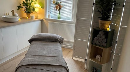 Serene treatment room at Regents Retreat, Nantwich, England, GB, featuring a massage table and elegant decor.
