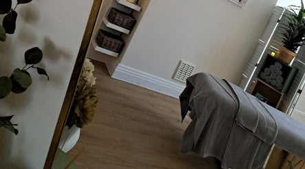 Cozy therapy room at Regents Retreat, Nantwich, England, GB, featuring a massage table and soothing decor.