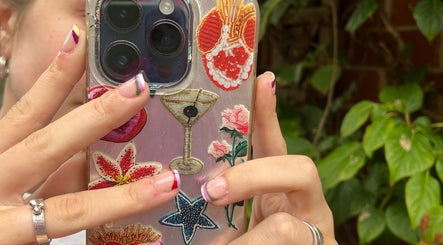 Colorful nail art with floral phone case at Steel and Polish Nails, Loxley, England, GB.