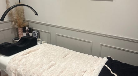 Cozy treatment bed at Blushed Beauty by Amelia, Wormegay, England, GB. Elegant decor creates a serene atmosphere.
