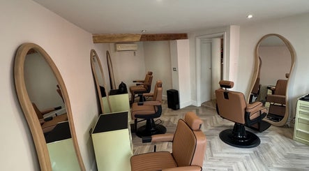 Modern barber chairs and mirrors at Reset Barbers in Beccles, England, GB, showcasing a sleek interior.
