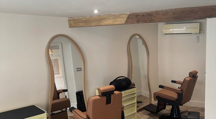 Interior of Reset Barbers in Beccles, England featuring modern barber chairs and stylish mirrors.