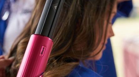 Hair styling with curling iron at Boots at Moonlight Meadows, Stradbally, County Laois, IE.