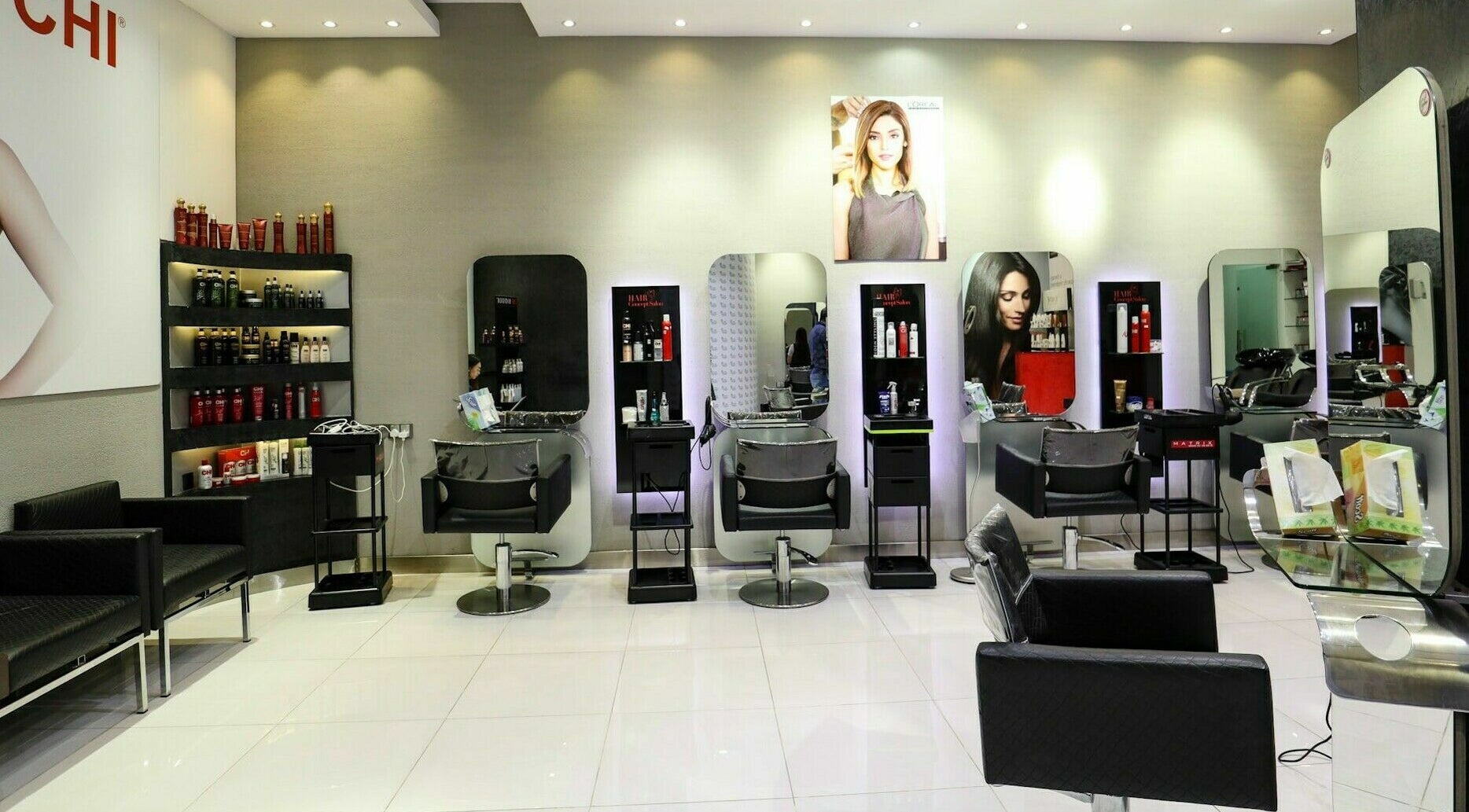 Modern salon interior at Hair Factory Ladies Salon in Abu Dhabi, Abu Dhabi, AE with styling stations and products.