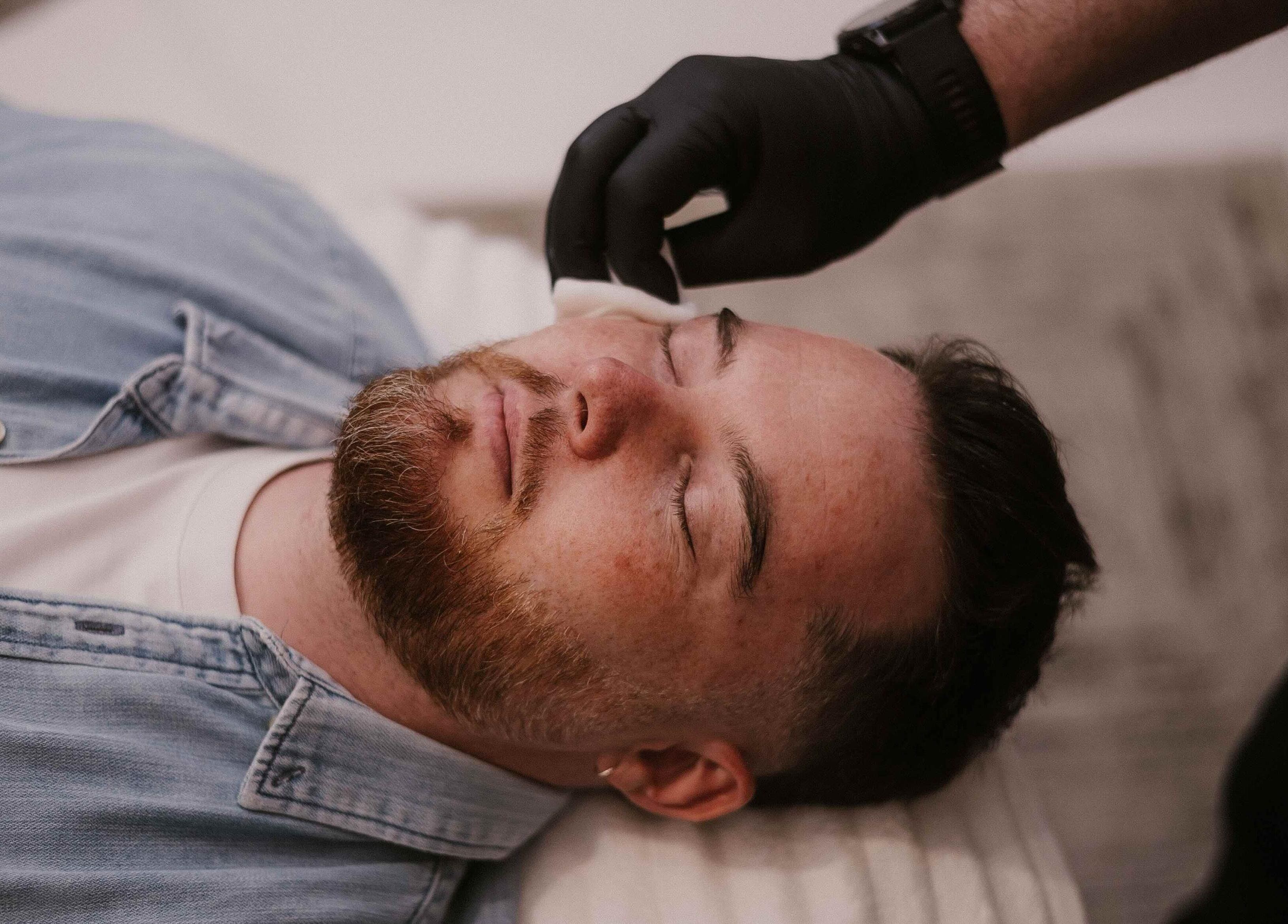 Facial treatment at Günther Oliver - Skin Medic / Joburg, Randburg, Gauteng, ZA. Man relaxing on treatment bed.