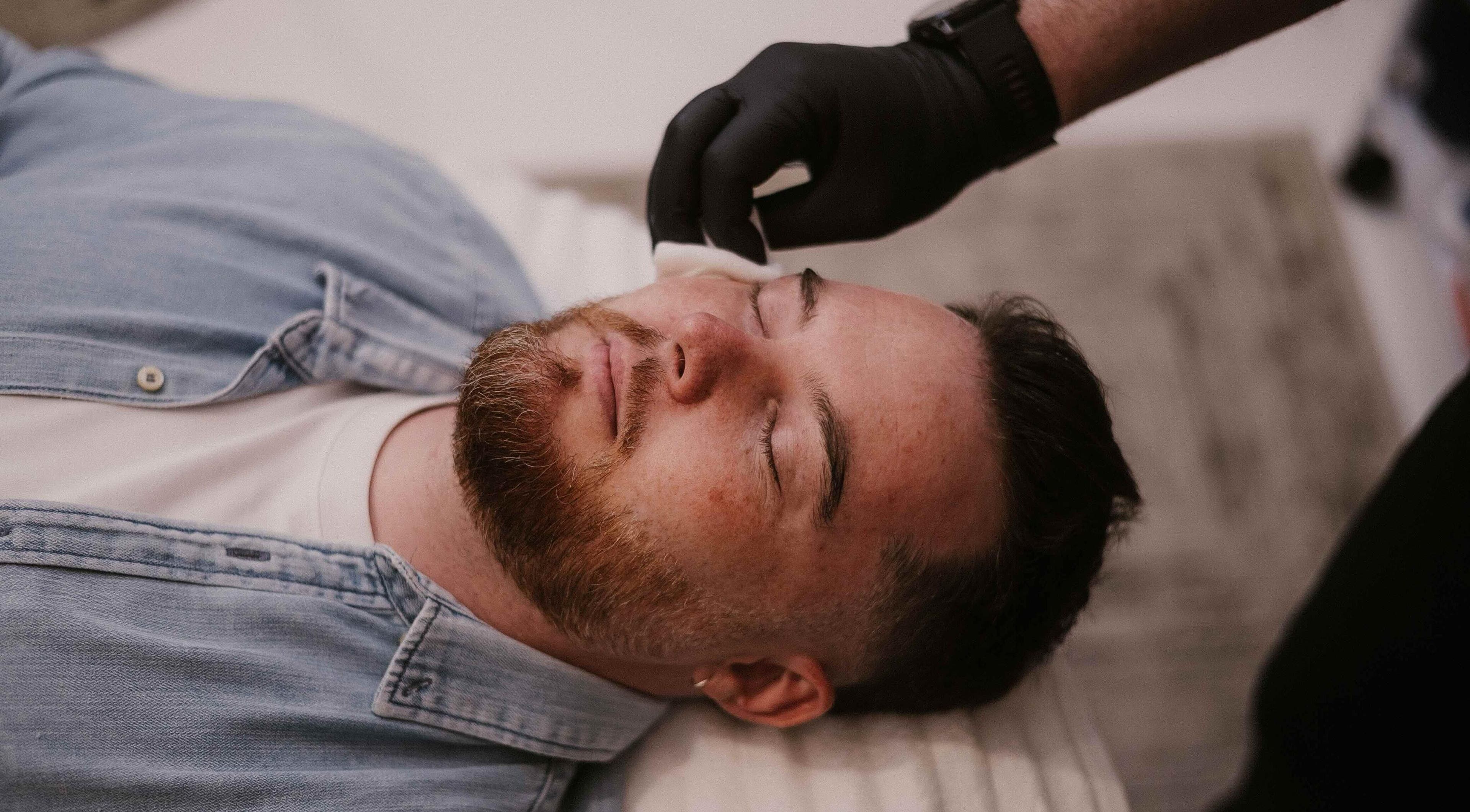 Facial treatment at Günther Oliver - Skin Medic / Joburg, Randburg, Gauteng, ZA. Man relaxing on treatment bed.