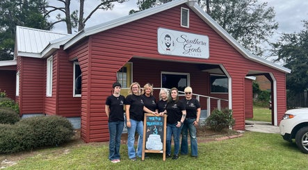 Team posing outside Southern Gents salon in Swainsboro, Georgia, US, celebrating their third anniversary.