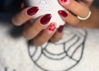 Elegant red and floral nail design at Dakkat Athiyah, Riyadh, Riyadh Province, SA.